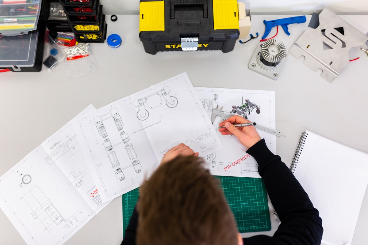 Close-up of an engineer's workstation displaying complex electrical design schematics for an industrial automation project.
